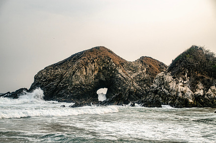 Mystical rock with gateway to ocean
