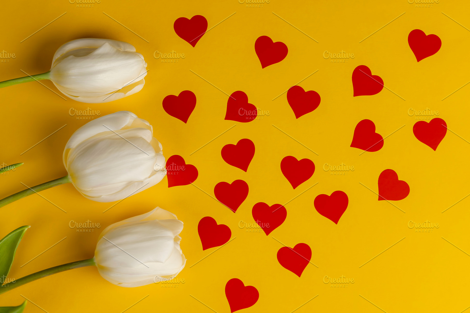 red hearts and white tulip flowers pasted on yellow paper, closeup, top view, a Photo by rsoollAI