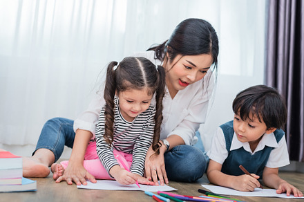 Mother teaching children in drawing class. Daughter and son pain, a Person Photo by Ministocker