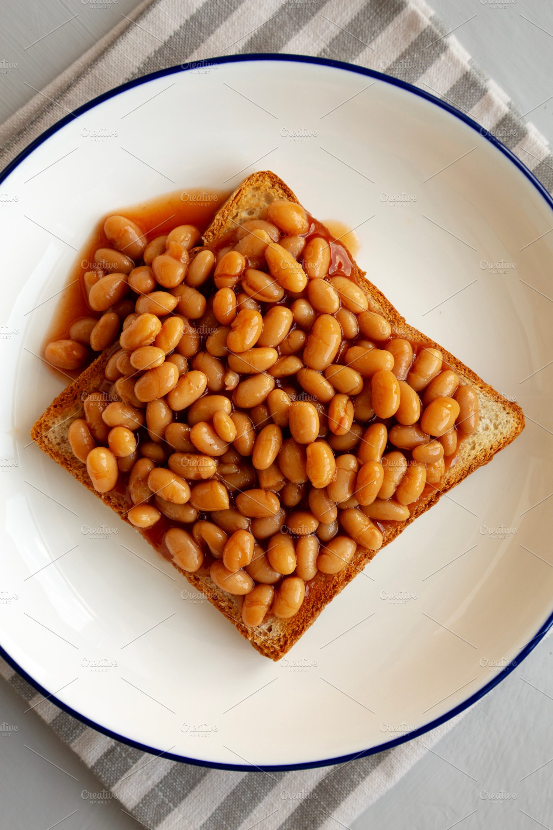 Homemade English Beans on Toast, top view. Close-up., a Food & Drink Photo by LiudmylaChuhunova