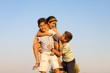 Three funny friends playing ina summer day