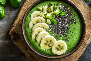 Green smoothie bowl with banana and, a Food & Drink Photo by Photostock