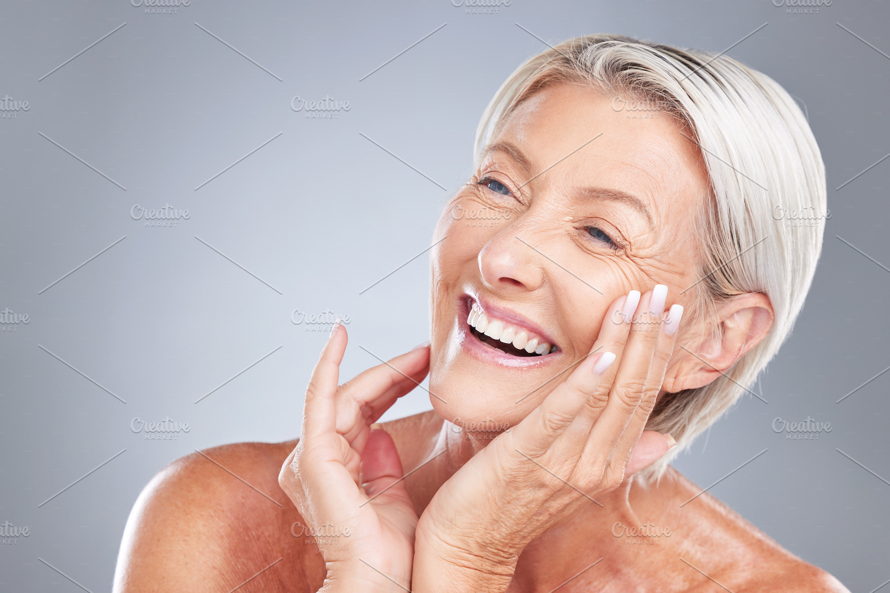 Skincare, beauty and senior woman with smile isolated in gray background studio. Wellness, dermatology and old female with natural skin and wrinkles pose for cosmetics, makeup and skincare products, a Photo by Peopleimages.com