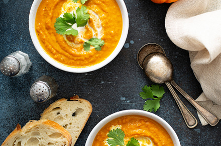 Pumpkin soup served with cream and cilantro, a Food & Drink Photo by farwasser