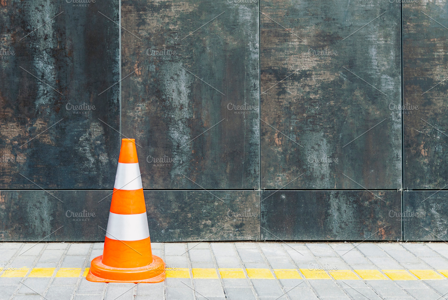Plastic traffic cone against wall, a Transportation Photo by BOOCYS