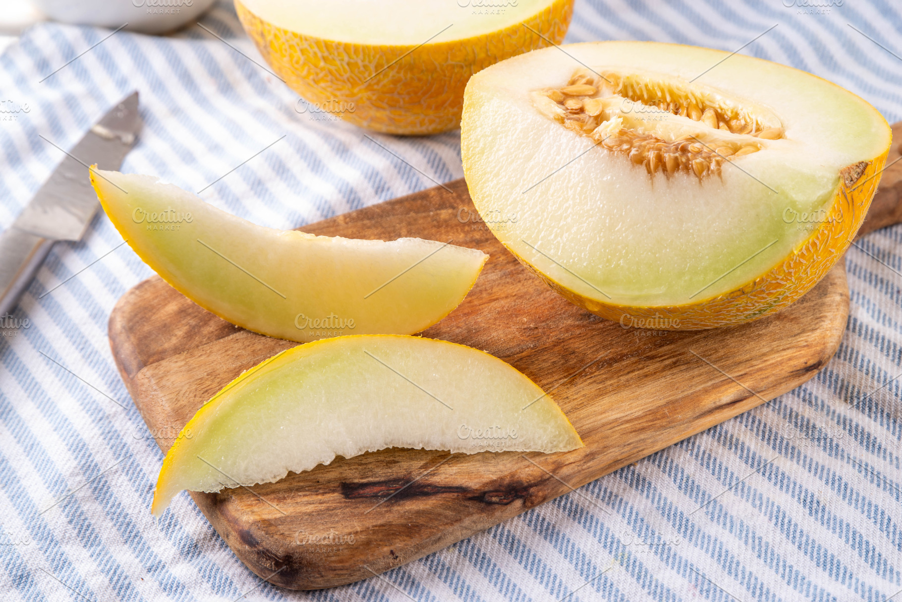 Tasty raw ripe cantaloupe melon on wooden table, a Food & Drink Photo by Rimma