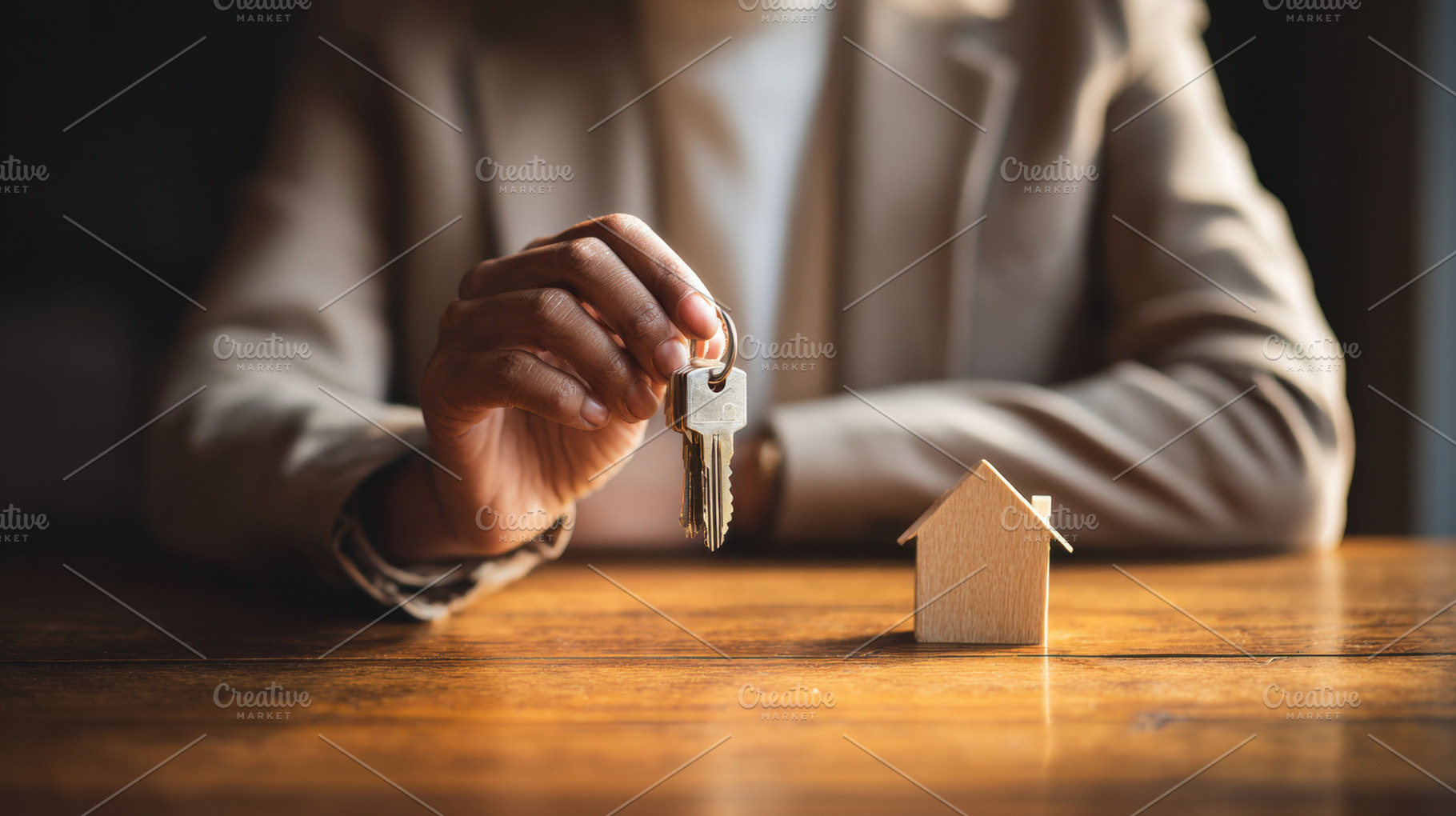 Holding keys in front of house model, a Photo by Beautiful things