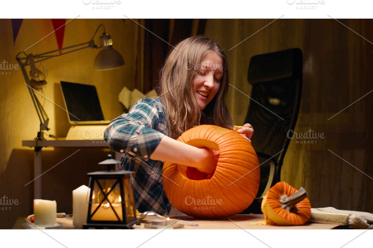 Woman carving Jack O Lantern pumpkin, a Graphic by sergeypeterman