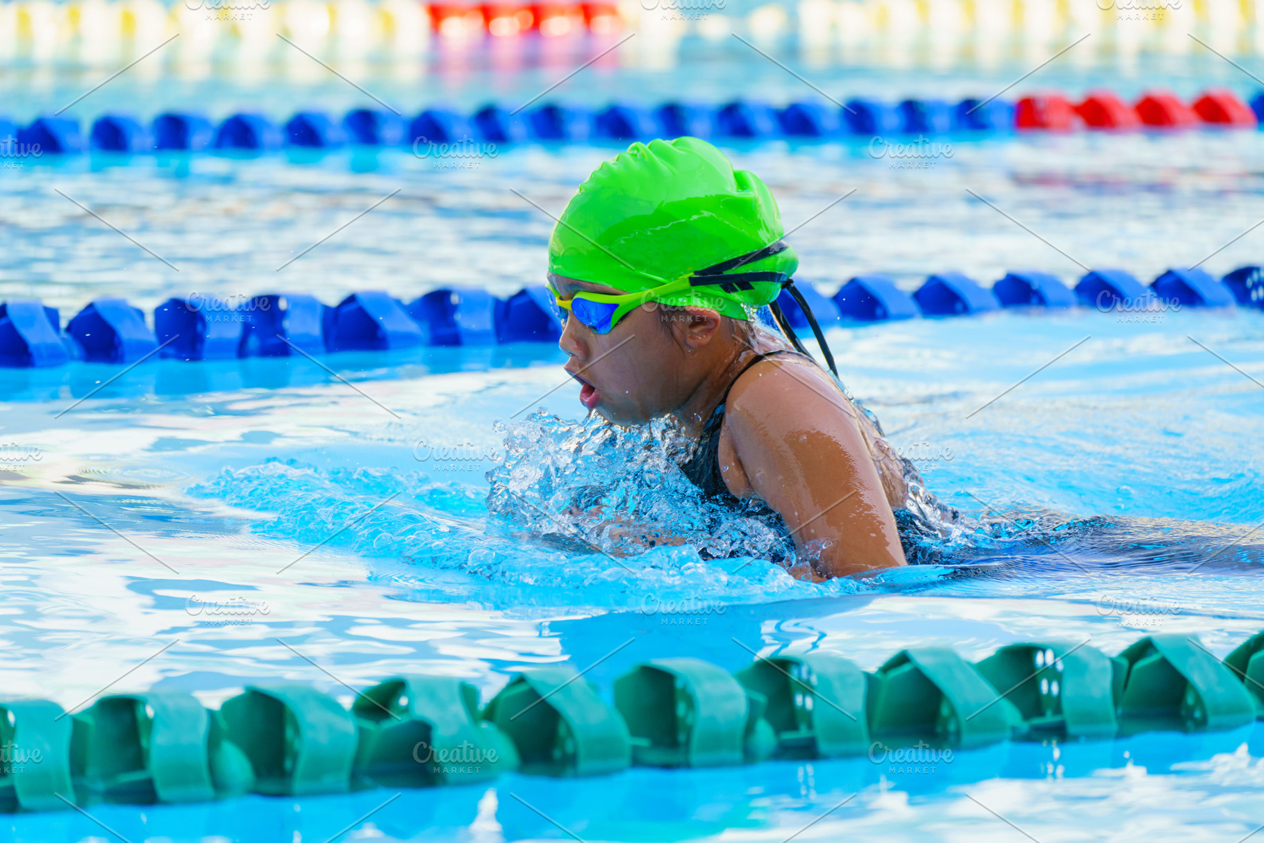 Swimmer child swims breaststroke swimming style in a race swimmi, a Sports & Recreation Photo by Casanowe-studio