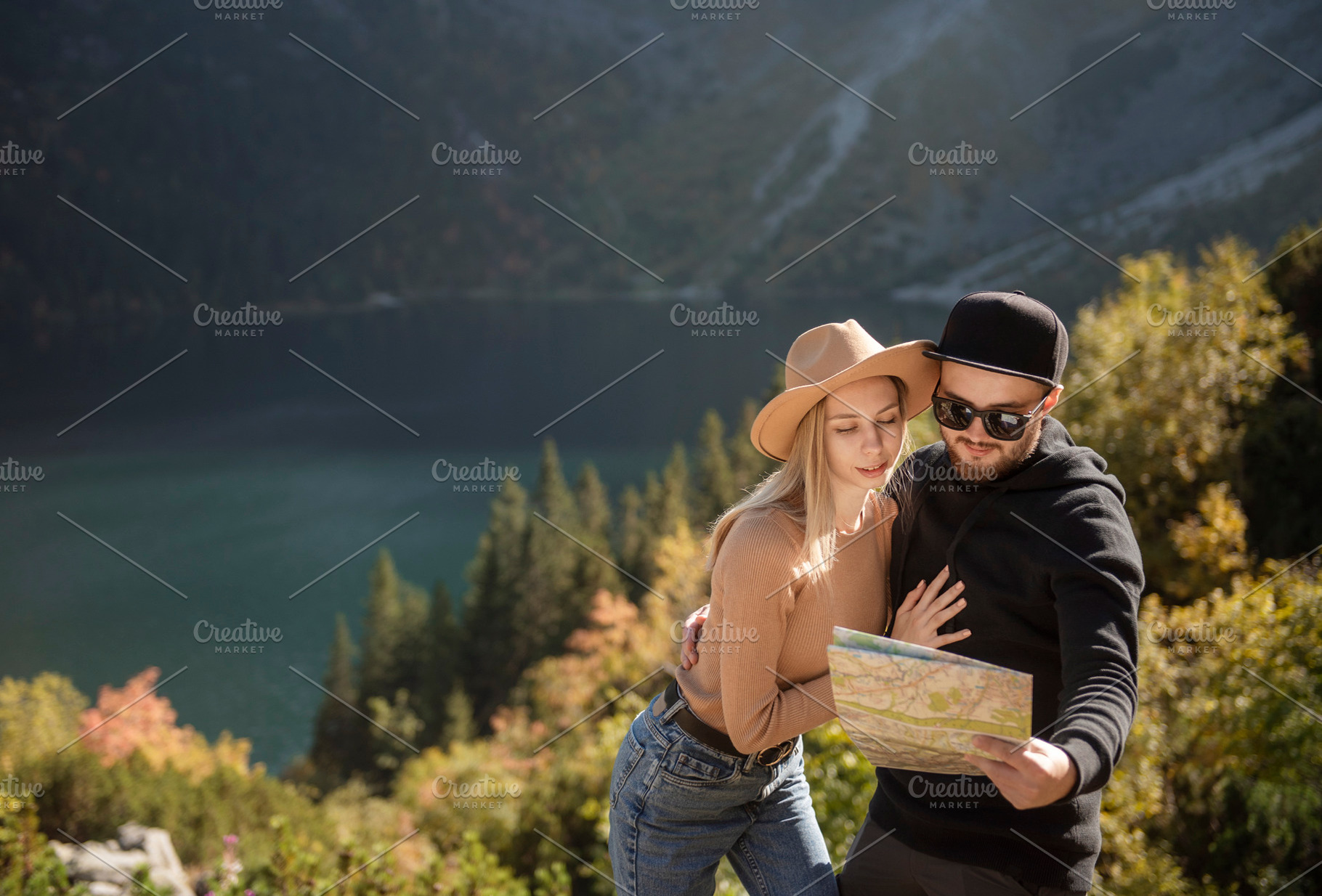 Young tourist couple, man and woman, on hiking path in mountains, a Person Photo by Olena Rudo