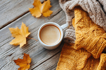 Cups of coffee and autumn leaves create a cozy scene on rustic wooden table, a Food & Drink Photo by AlyaAnd