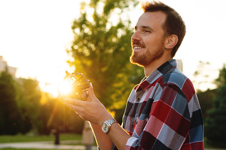 Smiling young man holding globe