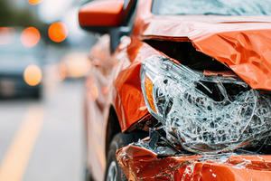 Damaged red car after accident on city street, a Transportation Photo by AlyaAnd
