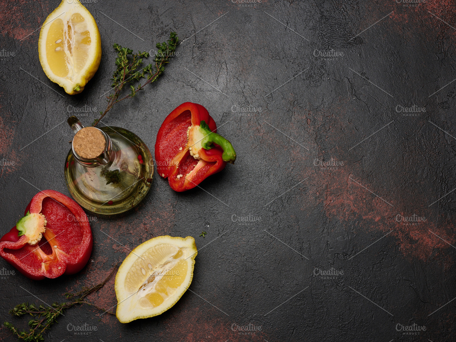 Red bell pepper halves, lemon, thyme sprigs, and a glass decante, a Food & Drink Photo by ndanko