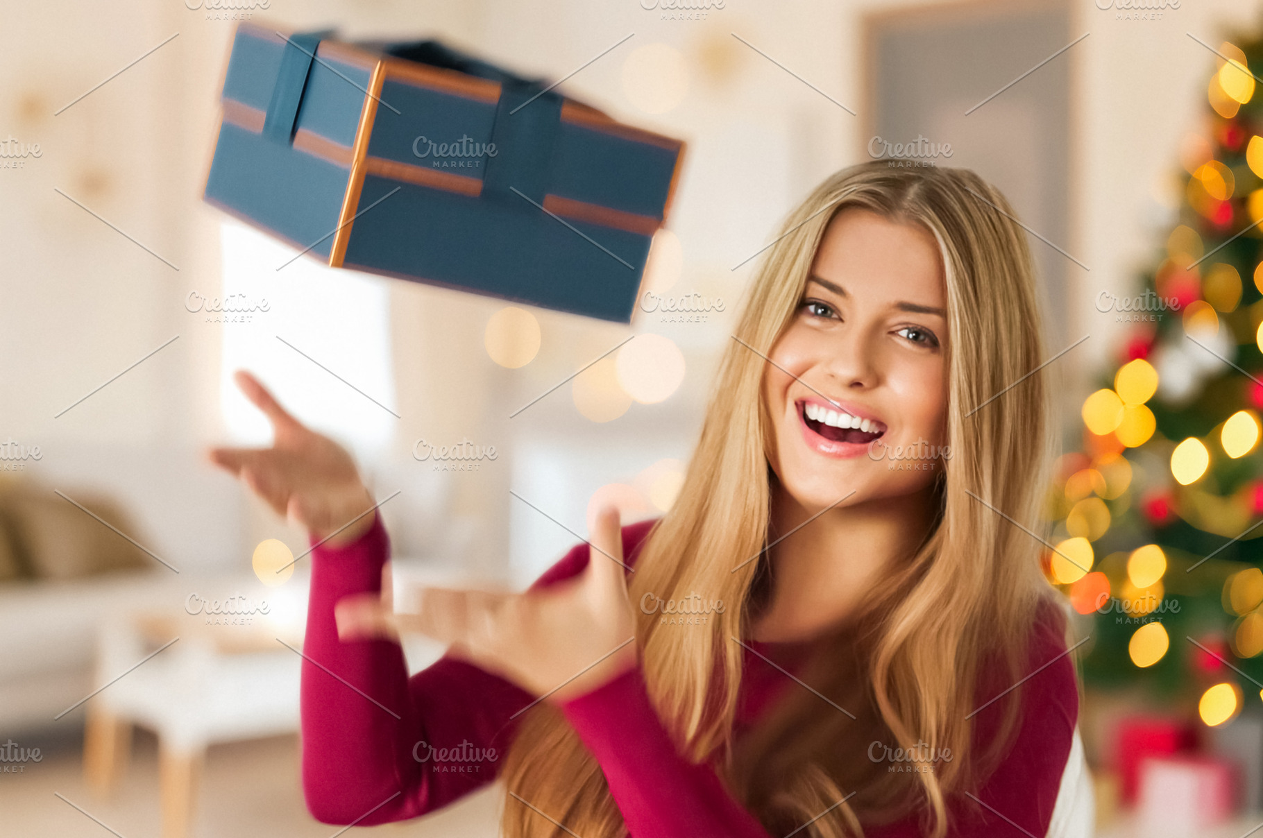 Young woman showing excitement and happiness, catching a flying, a Person Photo by Studio ANNA