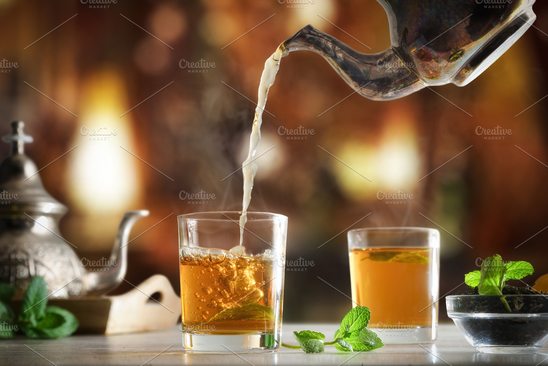 Pouring Moroccan tea into a glass in a tea room, a Food & Drink Photo by Davizro's Market