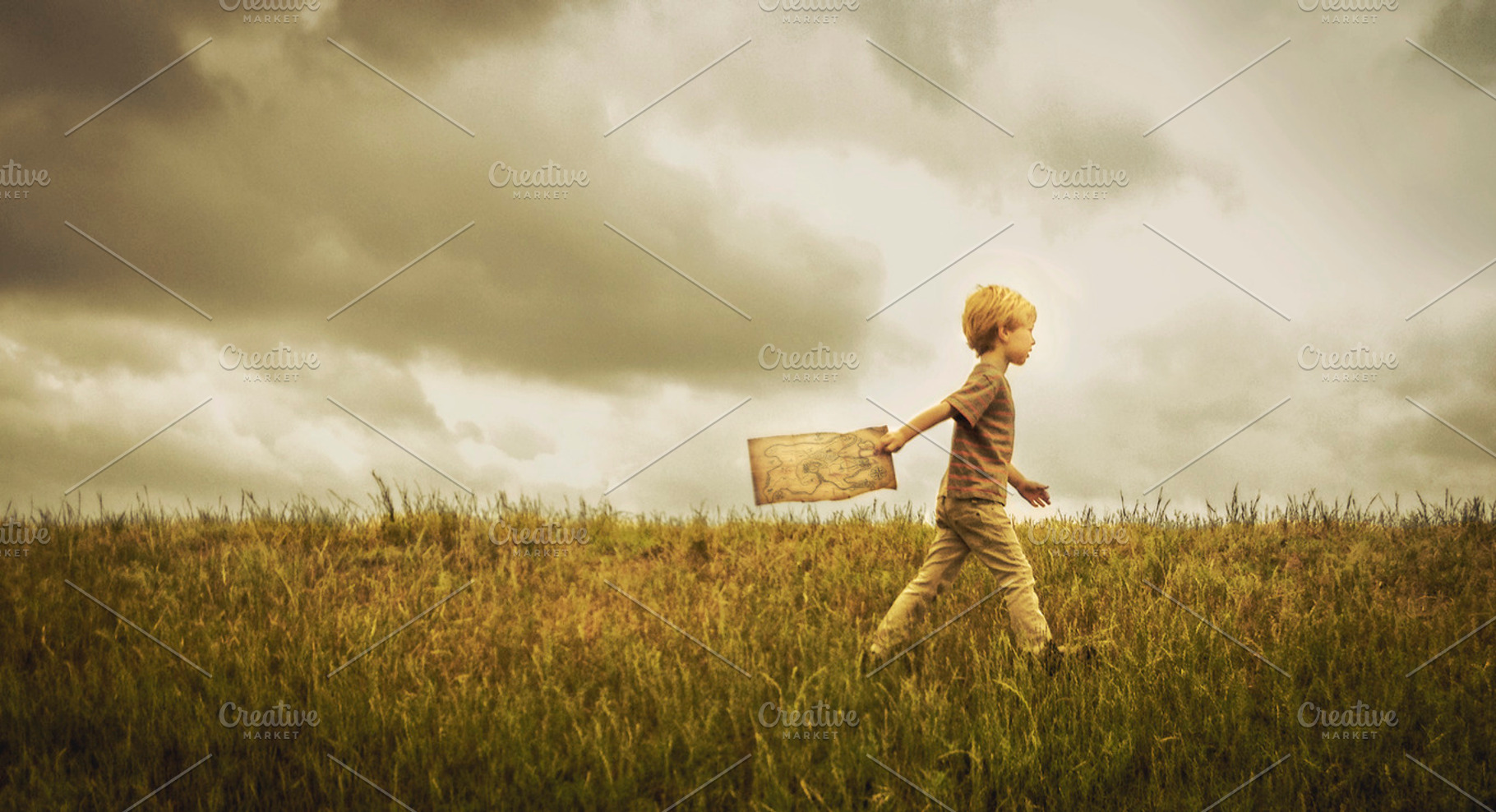 Boy Walking Across Grass With A Map