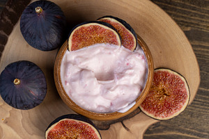 wooden bowl with fresh yogurt with ripe fresh figs, a Photo by rsoollAI