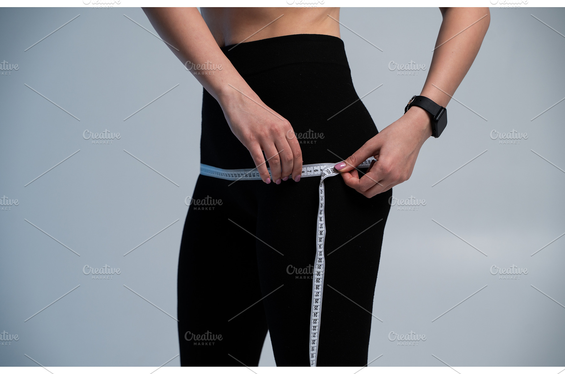 Woman measuring hips with a tape to, a Sports & Recreation Photo by volodymyrshtun13795