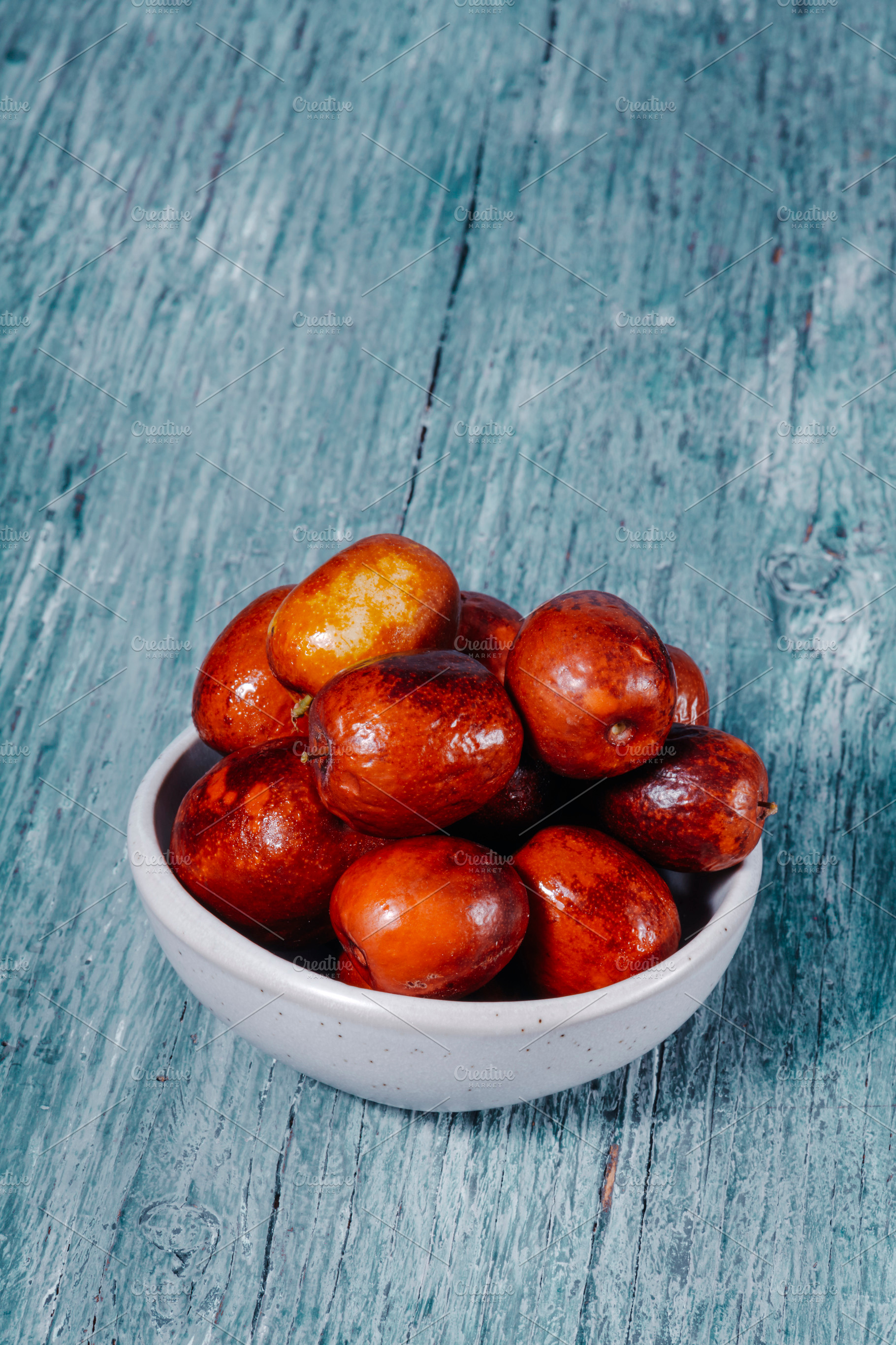 jujube fruits in a ceramic bowl, a Photo by Nito