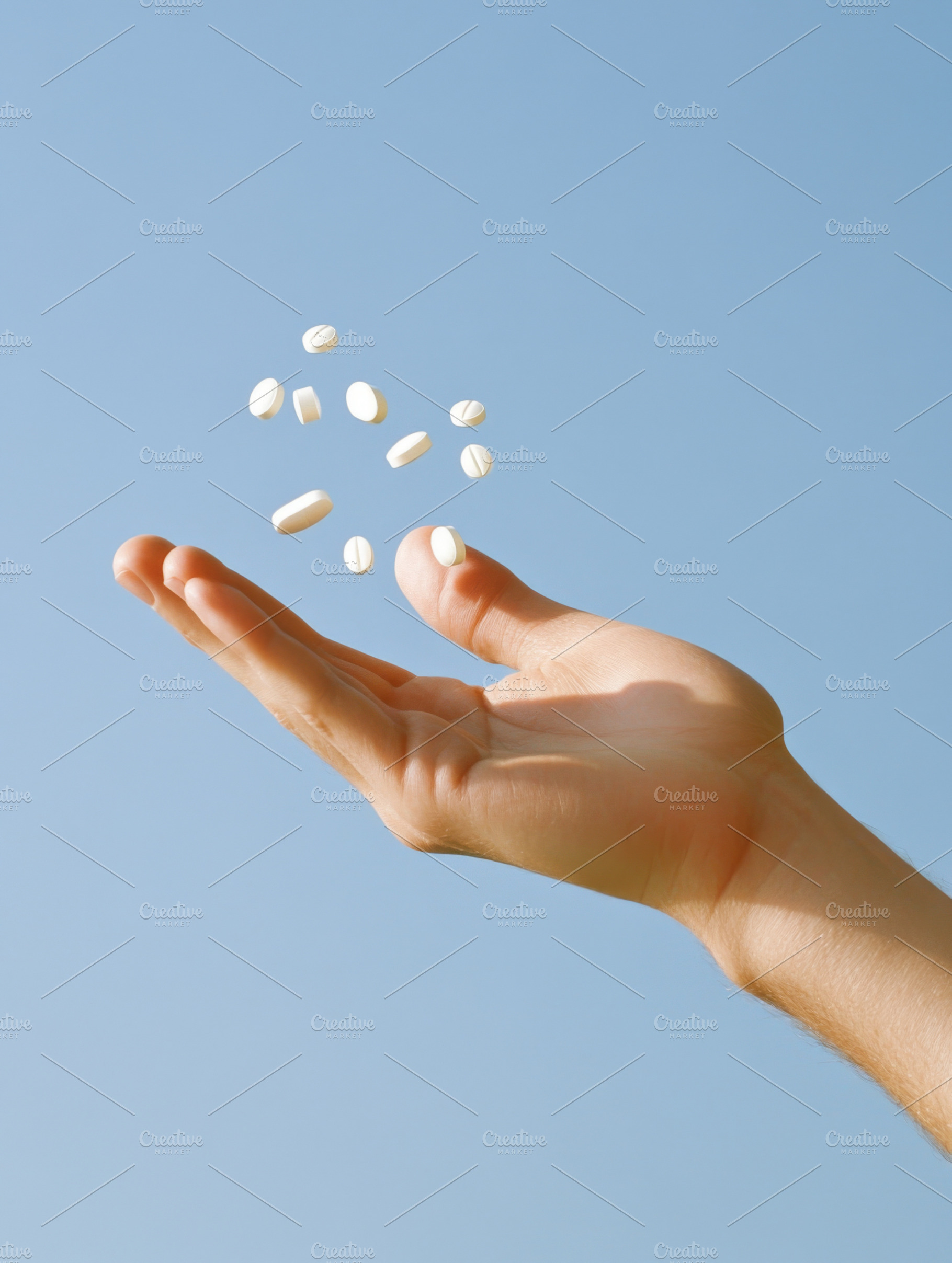 Hand with pills floating in the air, a Photo by Dvoevnore photos
