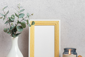 Eucalyptus branches, lit candle and empty photo frame creating c, a Background Photo by Olena Rudo