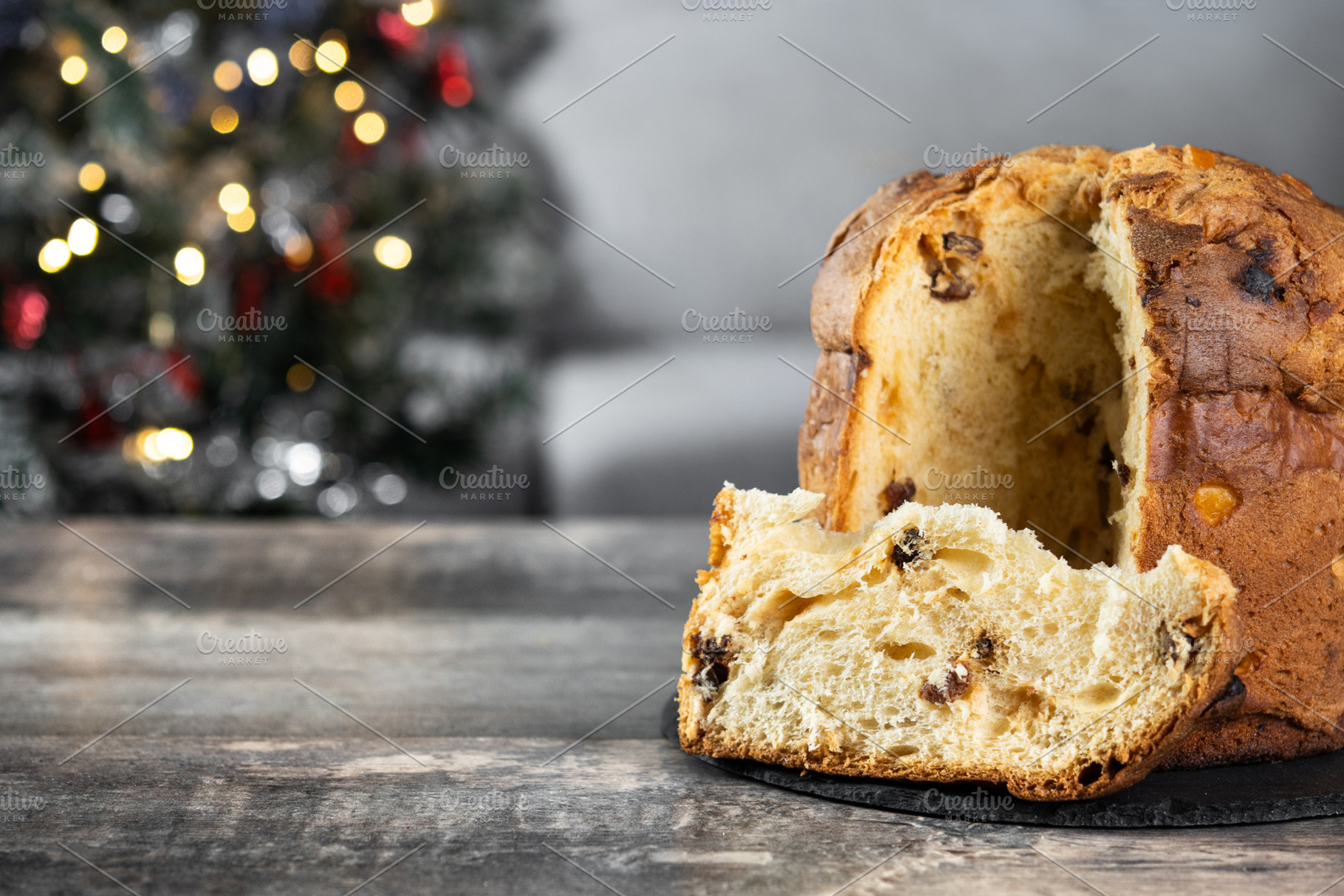 Traditional Italian Panettone on wooden table and christmas tree, a Food & Drink Photo by etorres69