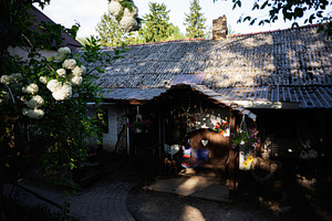 Rustic rural home with decorative elements in a tranquil garden setting, a Photo by AS photostudio