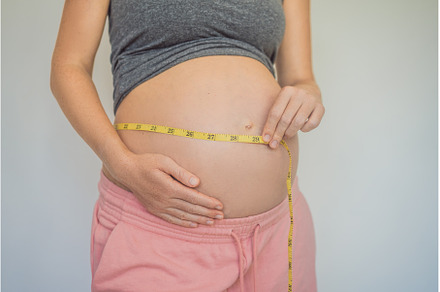 Young woman measuring her pregnant, a Person Photo by Elizaveta Galitskaya