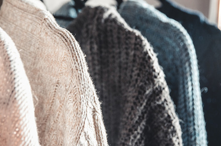 Collection of warm sweaters hanging, a Beauty & Fashion Photo by OS