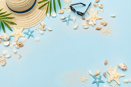 Beach accessories creating a summer holiday background on light