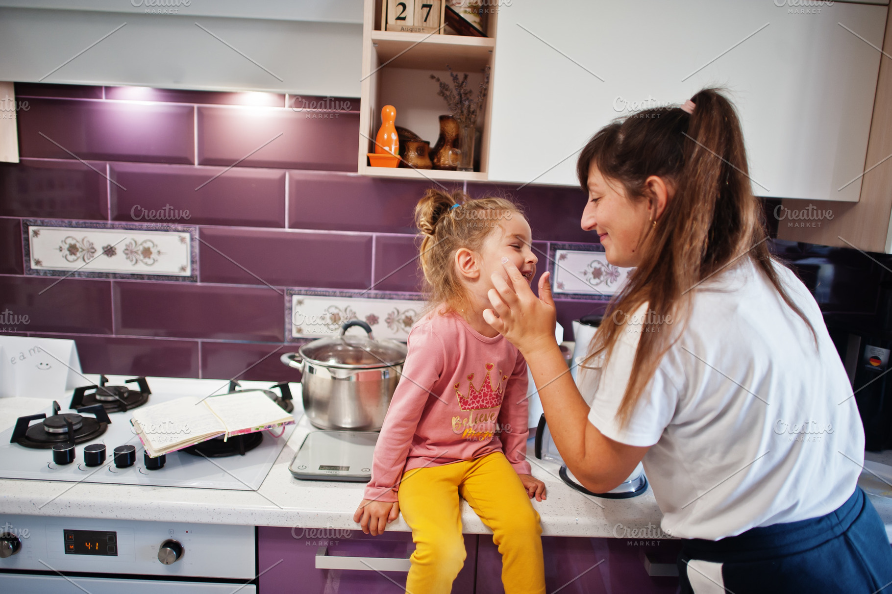 Mother with daughter cooking at kitchen, happy children's moment, a Person Photo by AS photostudio