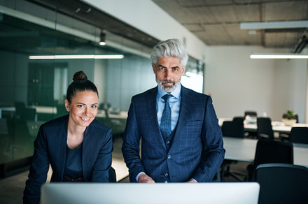 Two businesspeople with computer containing young, team, and staff