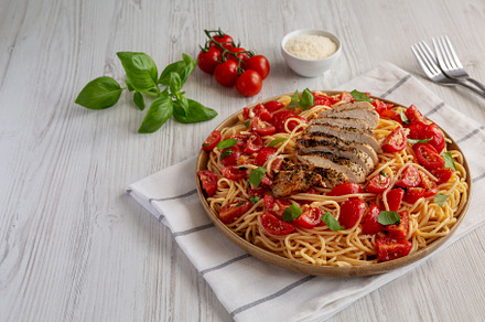 Homemade Bruschetta Chicken Pasta on a Plate, side view., a Food & Drink Photo by LiudmylaChuhunova
