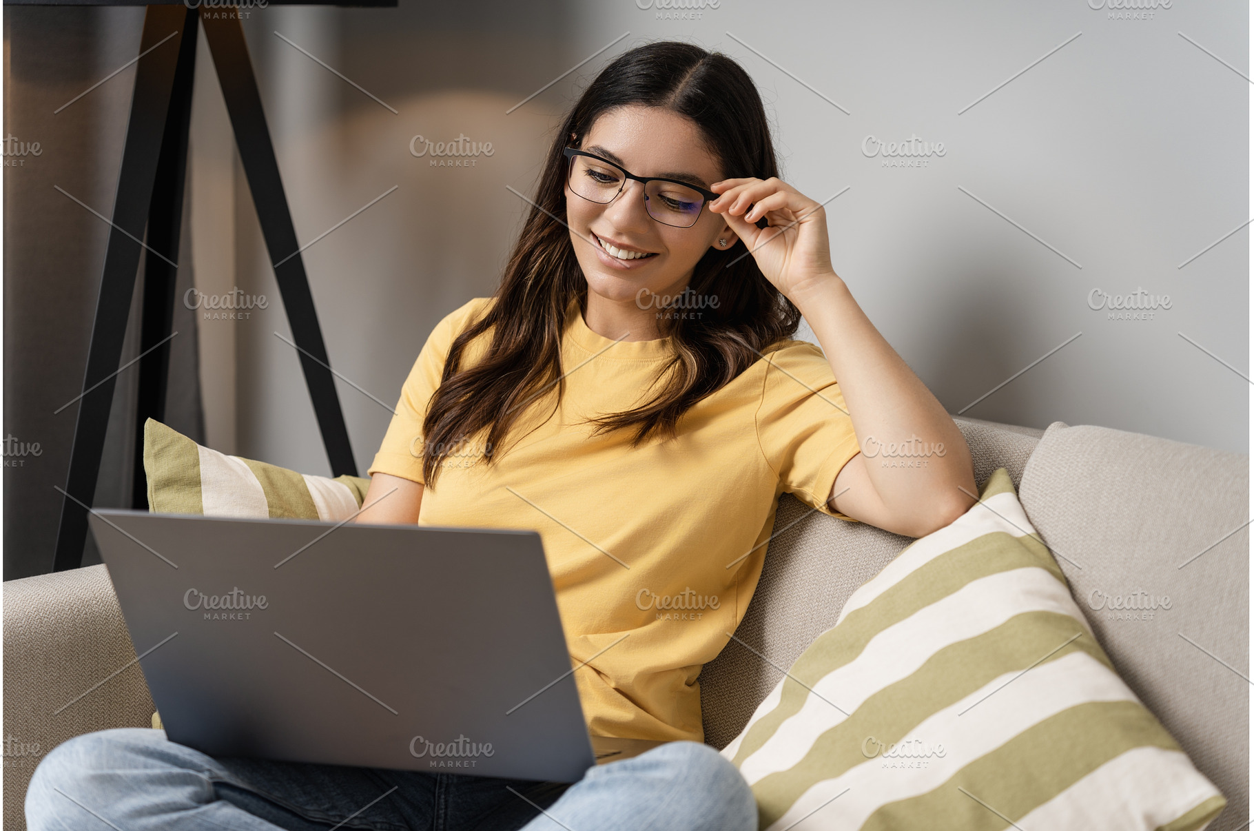 Woman sits comfortably on the couch, a Person Photo by AD Stock Images