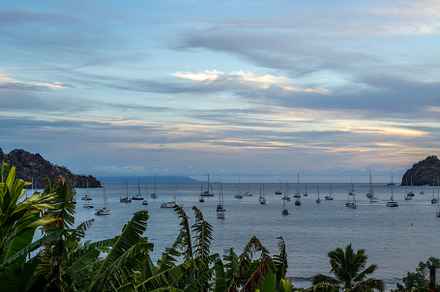 Taiohae Bay at sunset with sailboats in Nuku Hiva, Marquesas Isl
