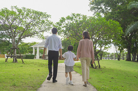 Portrait of happy smiling Asian Family walking together in publi, a Photo by Tampatra