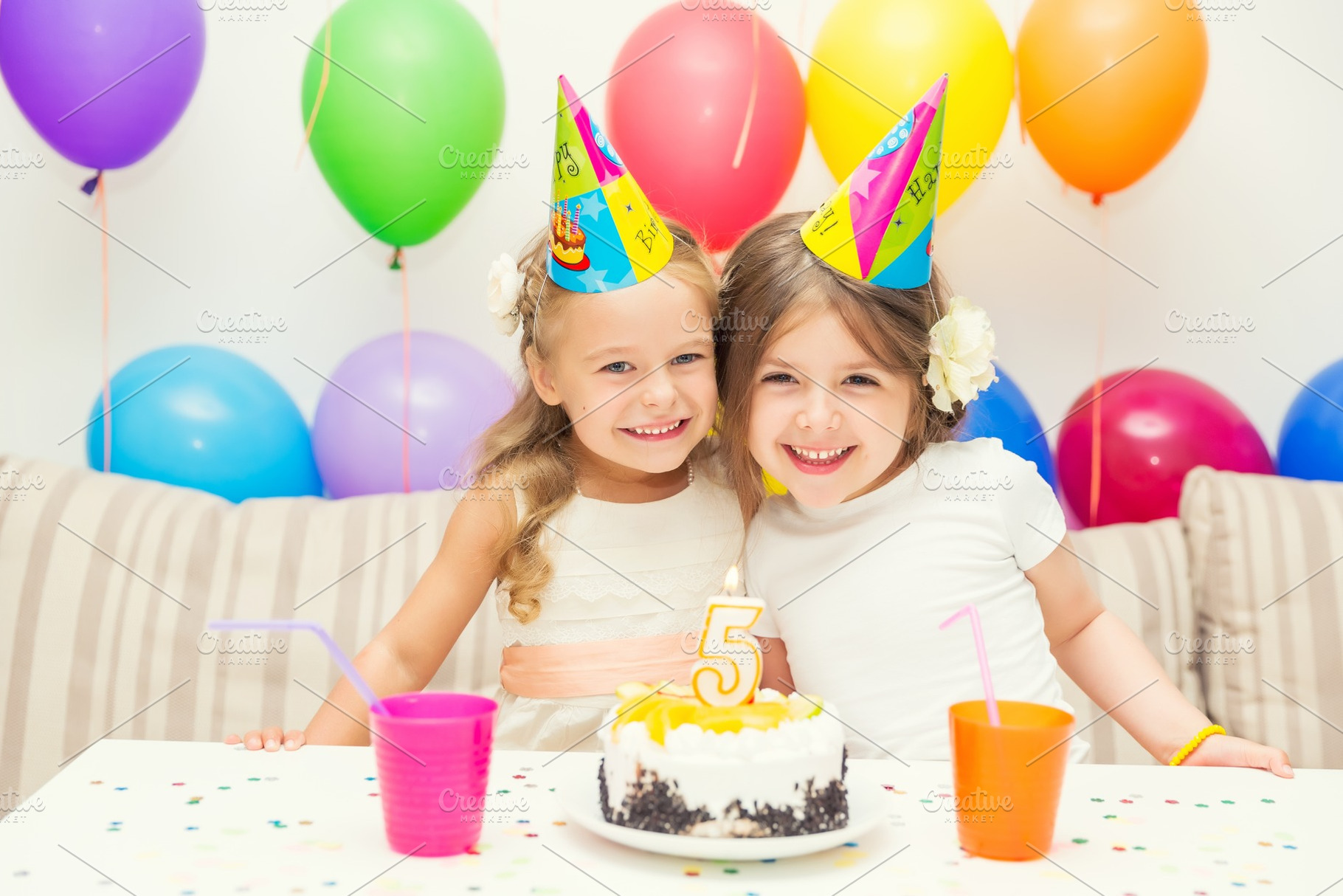 Two little girls at birthday party stock photo containing birthday and party, a Person Photo by sborisov