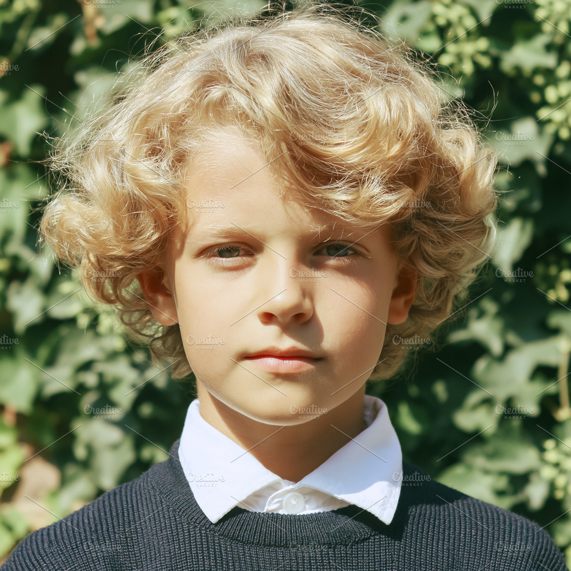 Cute boy with blonde curly hair and blue eyes, wearing a simple, a Person Photo by Studio ANNA
