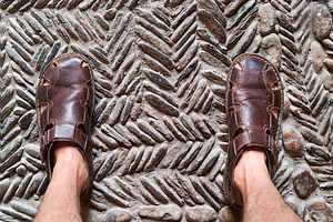 Feet on textured floor mat seen from above, a Person Photo by DanFLCreativo