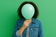 Young person holding green balloon a, a Photo by Dvoevnore photos (Thumbnail 3 of 3)