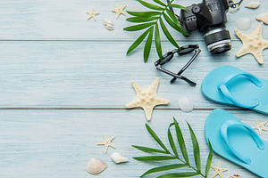 Beach vacation accessories arranged on rustic blue wooden backgr, a Holiday Photo by Olena Rudo