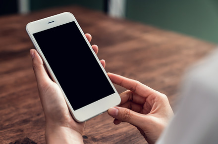 Hand holding smartphone mockup of bl containing technology, phone, and