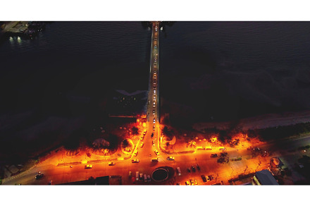 Cars driving at night on bridge over