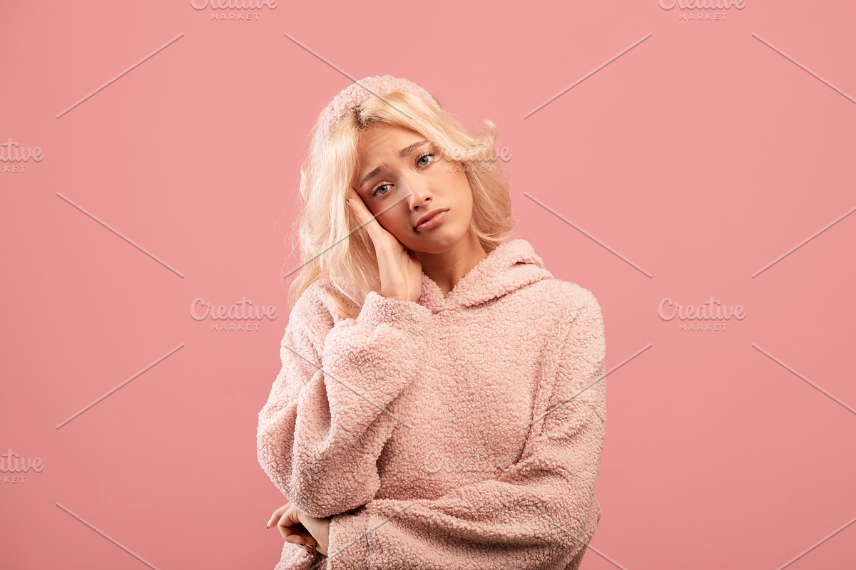 Bored young woman feeling upset and depressed, looking at camera, posing over p, a Photo by Prostock-Studio (Photo 2 of 2)