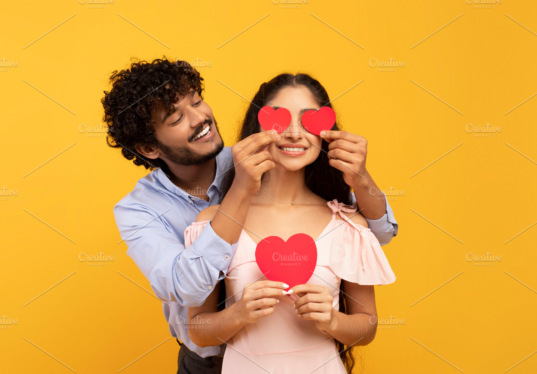 Affection. Loving indian husband covering wife's eyes with paper hearts, posing, a Person Photo by Prostock-Studio