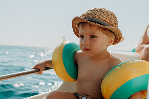 A small boy with arm floaties, a Person Photo by HalfPoint