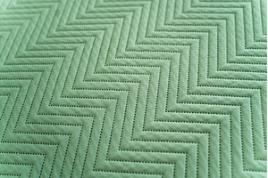 Diagonal closeup of green stitched, a Background Photo by volodymyrshtun13795