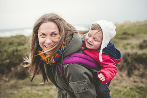 Mother carrying her toddler stock photo containing baby and family