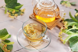 Linden flower herbal tea brewing in glass teapot, a Food & Drink Photo by Olena Rudo